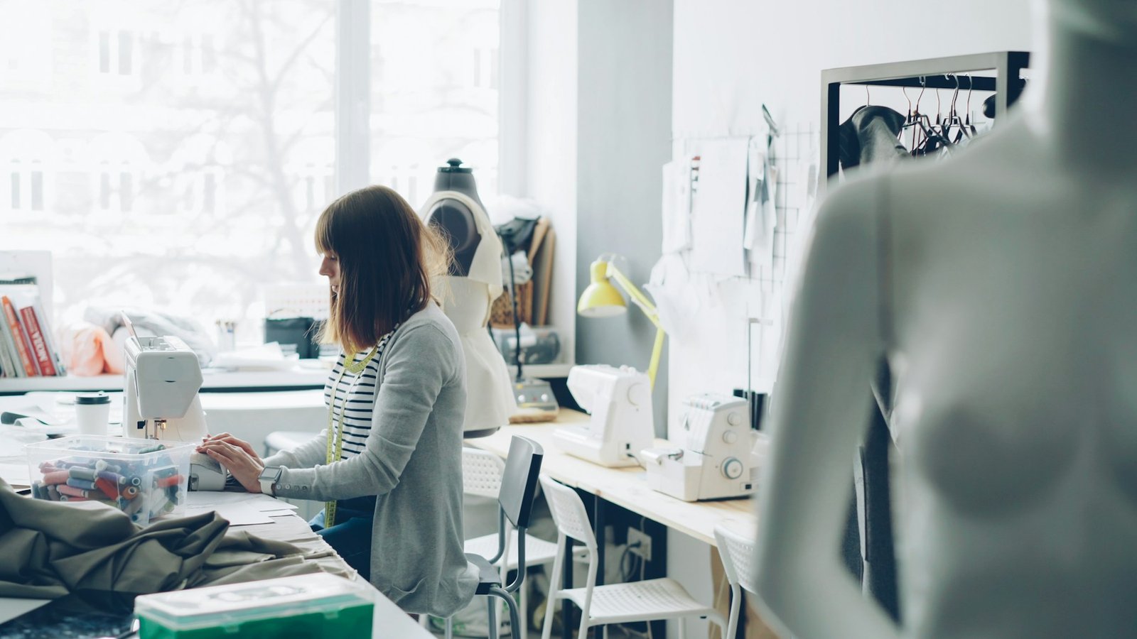 Fashion student working at a sewing machine in a workshop